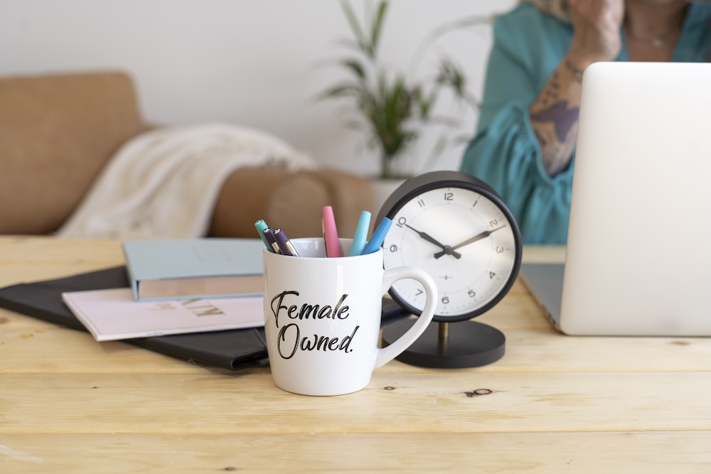 woman's desk with female owned mug